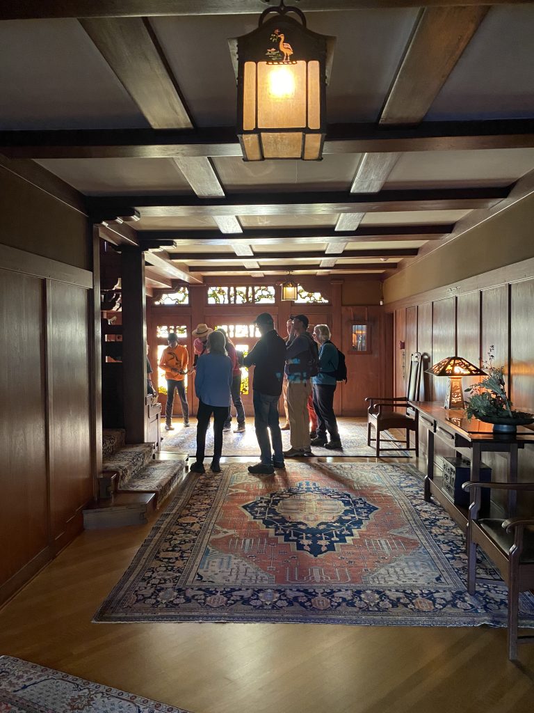 Visitors talking to the staff of The Gamble House at the entry hall.